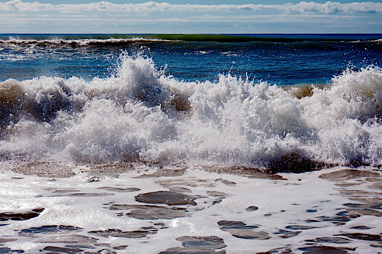 crashing waves tumbled him helplessly along the bottom until the churning surf spit him out on shore